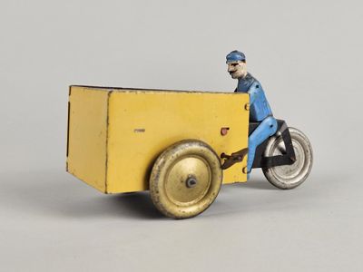 a toy of a man riding a motorcycle with a cart on the back