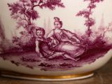 a purple and white vase with a picture of a woman and a child
