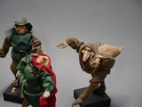 three figurines of a man and a woman dressed as elves