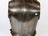 a close up of a metal armor on a white surface