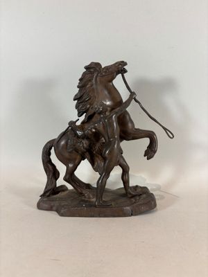 bronze statue of a man on a horse with a lasser