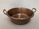 an old copper pot with handles on a white background