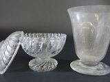 three glass vases sitting on a table next to each other