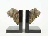 pair of art deco bookends with lion heads on black marble bases