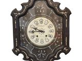 a clock that is hanging on the wall on a white background