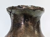 a brown vase that is sitting on a table