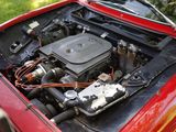 a red car with an engine in the trunk of it