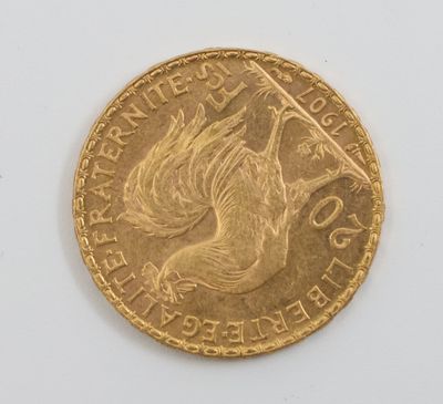 a close up of a gold coin on a white surface