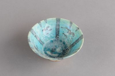 un petit bol bleu posé sur une table