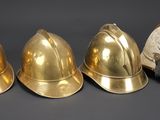 three different types of helmets are lined up on a table