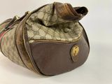 brown guccissi bag on white background with zipper open