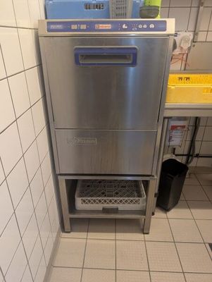 a stainless steel dishwasher in the corner of a kitchen