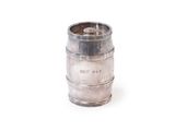a metal barrel that is sitting on a white surface