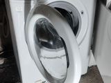 a washer and dryer sitting next to each other on the floor