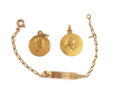 a close up of a chain with two gold medals on it