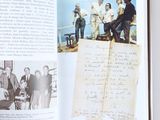 an open book with a picture of a group of people