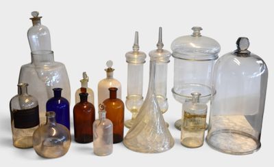 many glass bottles with different types of liquids in them