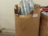a brown bag full of plastic cups sitting on a carton in a room
