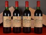 three bottles of red wine sitting on a table next to a wooden box