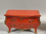 pair of orange and gold painted chest of drawers
