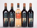 three bottles of wine sitting next to each other on a white surface