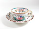 a cup and saucer on a saucer on a white surface