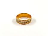 a close up of a gold ring on a white surface