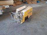 a machine that is sitting on the ground in the garage