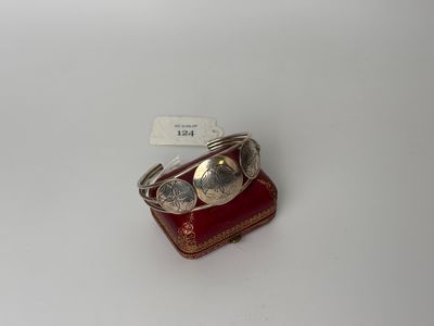 a close up of a silver ring on a red box