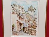 aquarelle encadrée représentant une scène de village, dans un cadre rouge