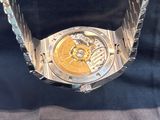 an image of a close up of a watch with a chain around it
