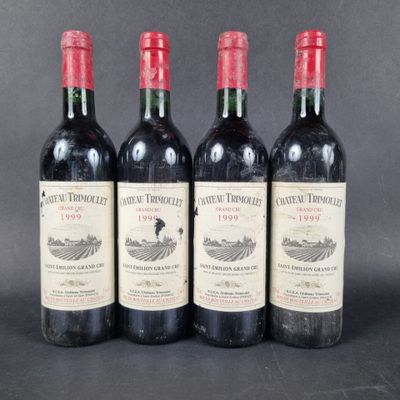 three bottles of red wine sitting on top of a table