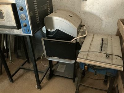 two microwaves and a toaster sitting next to each other in a room