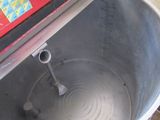 a red machine that is sitting inside of a metal bowl