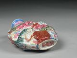 a small vase with a fish design on it