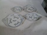 four plates and bowls sitting on a table