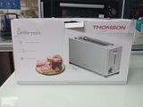 emballage d'un grille-pain posé sur un plan de travail à côté d'un autre grille-pain