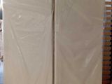 two mattresses stacked on top of each other in a room