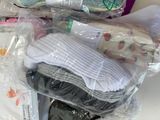 a pile of baby items in plastic bags on a table
