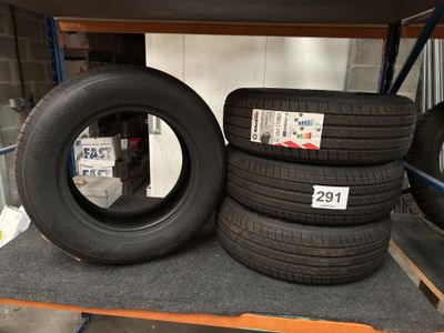 four tires on a shelf in a store