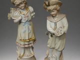 pair of porcelain figurines of a boy and a girl