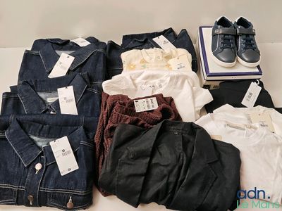 several pairs of men ' s clothing are laid out on a table