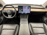 the interior of a tesla vehicle with a touch screen and steering wheel