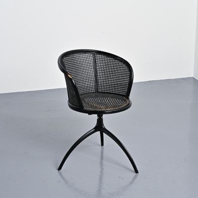an image of a black chair sitting on top of a gray floor