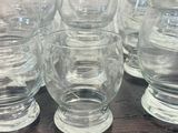 several empty glasses sitting on top of a wooden table
