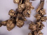 a necklace made of gold flowers and leaves on a mannequin