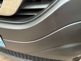 a close up of a car ' s grille with a sticker on it