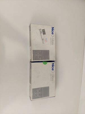 two boxes of toothpaste sitting on the wall