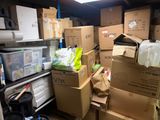 many boxes stacked on top of each other in a room