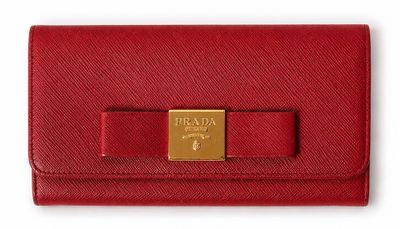 a red wallet with a gold bow on the front